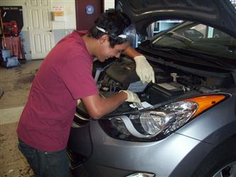 student working on car